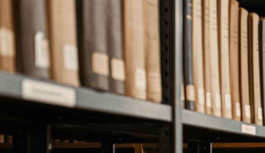 Reaching for a ledger in a working records room